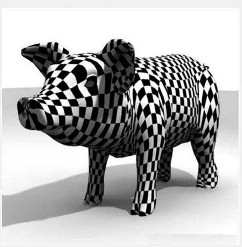 Artystycznie malowane figury zwierząt 2 Figurka świni pokryta czarno-białym wzorem w kratkę.