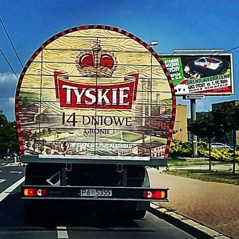 Reklama mobilna - TYSKIE z TANKA 4 Ciężarówka z logo Tyskie na 14-dniowe piwo na ulicy.